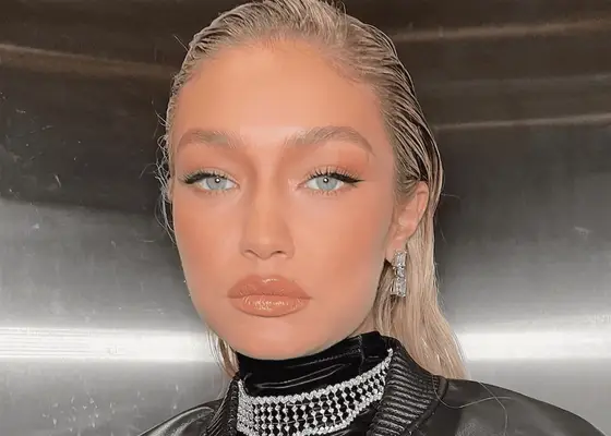 Gigi Hadid with slicked back hair, bold black eyeliner, and her bright blue eyes