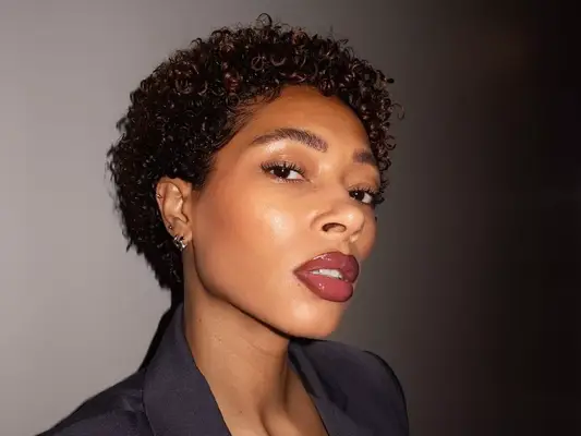 Woman with glowy makeup look and curly hairstyle