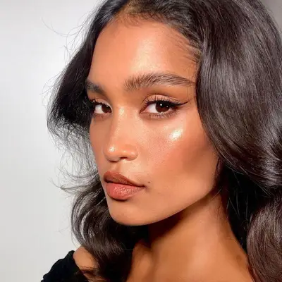 Model in a dewy bronze makeup look
