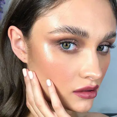 Model with a clean, radiant summer makeup look