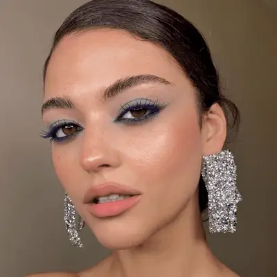 model wearing blue eyeshadow and mascara