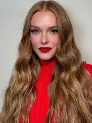 woman with strawberry blonde hair and red lips