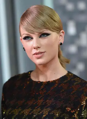 Taylor Swift with a graphic eyeliner look and sleek hair