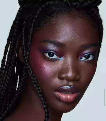 model is wearing a shimmering metallic lilac and blue eyeshadow look