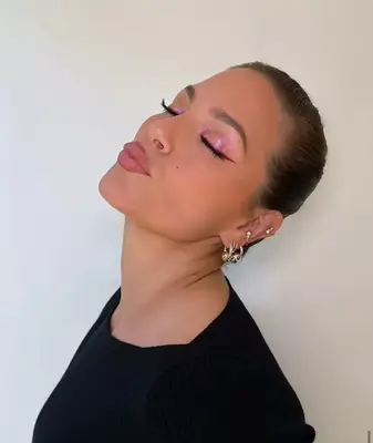 Ashley Graham wears a sparkling lilac eyeshadow look