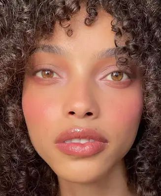 up close photo of a model wearing a barely there lilac matte eyeshadow applied to the inner corners and lid