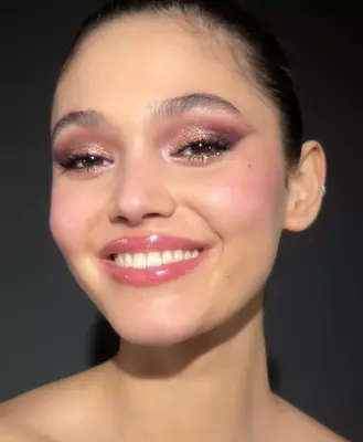 photo of model wearing a sparkling lilac and purple eyeshadow look with glitter placed on the center of the eyelids