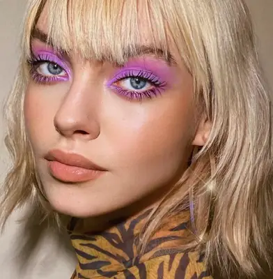up close photo of a model wearing a vibrant matte lilac eyeshadow look