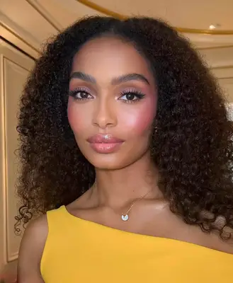 up close photo of yara shahidi wearing a soft lilac eyeshadow look