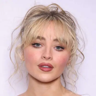 Sabrina Carpenter with natural eye makeup, freckles, and pink lip.
