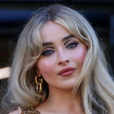 Sabrina Carpenter with a bold and artistic eyeshadow loop and pink lip.