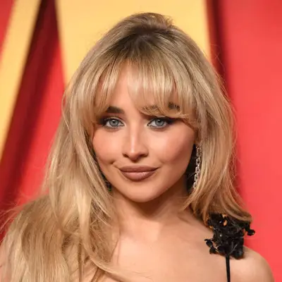 Sabrina Carpenter with a smokey eye and dark nude lip.