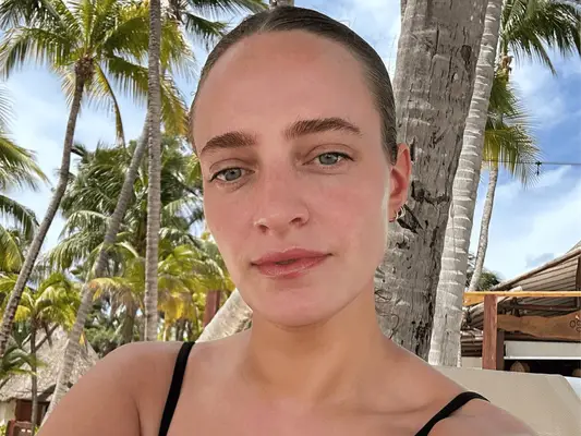 Women with bold brows in a beach setting. 