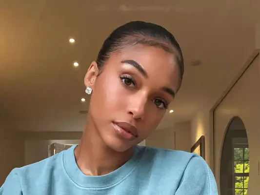 Close up of socialite Lori Harvey, her head slightly to the side