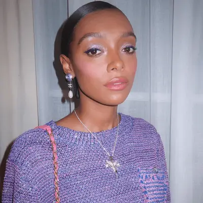 Model with shimmery lilac eyeshadow, and bubblegum pink cheeks and lips.