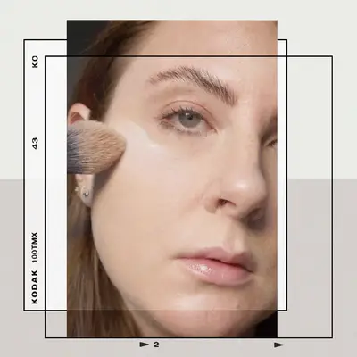 Woman Applying Foundation with a Makeup Brush Using the 