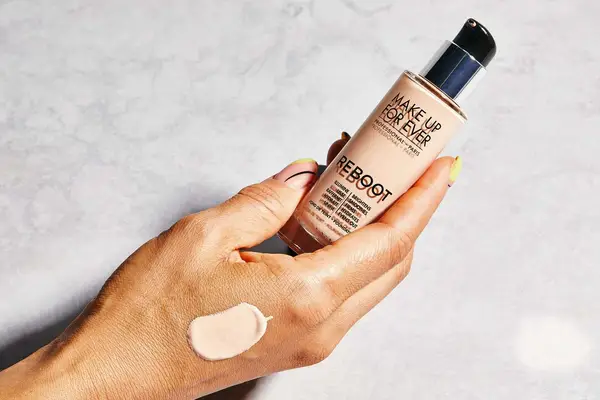 Photos of person’s face before and after using Nars Light Reflecting Advanced Skincare Foundation