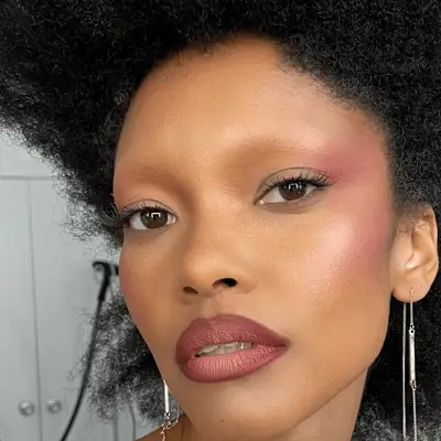 woman wearing monochrome purple makeup