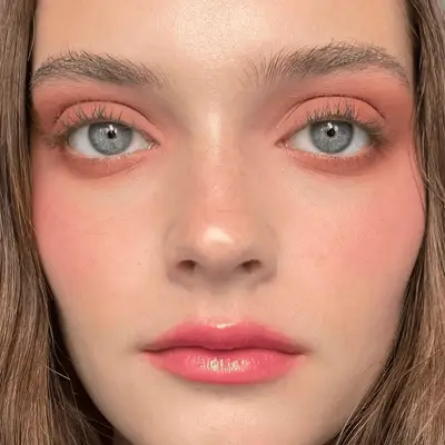 model wearing monochrome peach makeup