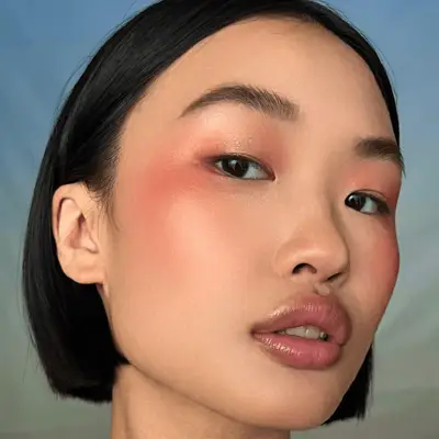 model wearing monochrome peach makeup