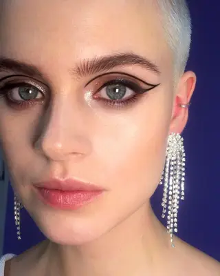 Model with graphic black eyeliner and platinum buzz cut