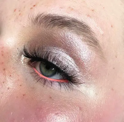 Silver eyeshadow with peach liner on lower waterline