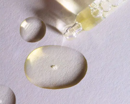 Drops of minoxidil on a white background