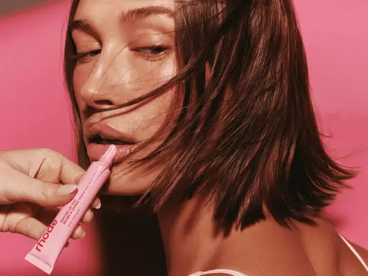 Hailey Bieber applying Rhode