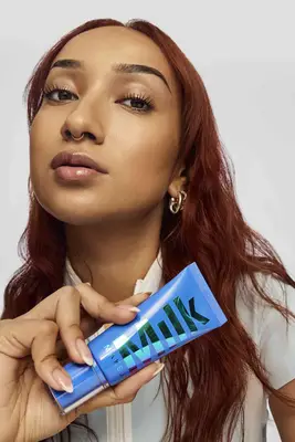 model holding Milk Makeup skin tint