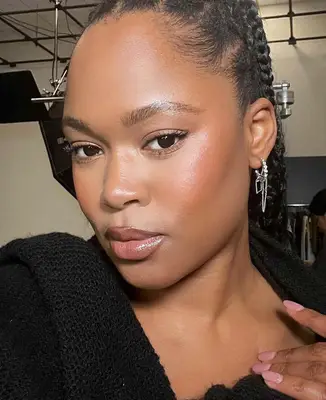 model wears a natural, soft and glowy makeup look with highlighted skin