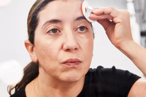 Person applying Chantecaille Future Skin Cushion Skincare Foundation to their face