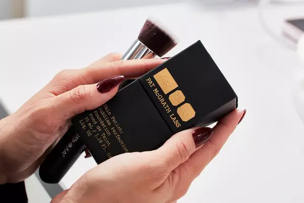 Hands holding Pat McGrath Labs Skin Fetish Sublime Perfection Foundation