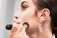 Person applying foundation to their cheek