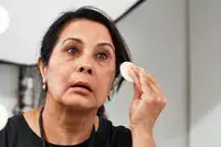 Person applying foundation on their face with a makeup sponge