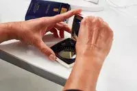 Hands opening Estee Lauder Double Wear Stay-in-Place Matte Powder Foundation compact