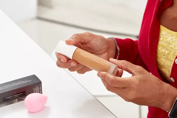 Person holding a bottle of Fenty Beauty Pro Filt