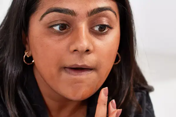 Person applying KVD Beauty Good Apple Skin-Perfecting Hydrating Foundation Balm with their hands