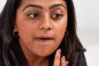 Person applying KVD Beauty Good Apple Skin-Perfecting Hydrating Foundation Balm with their hands