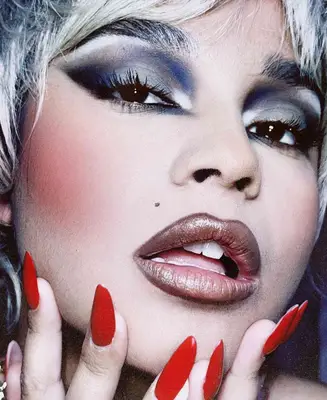 model wears bold makeup look with brown frosted lip color