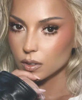 model wears a soft glam makeup look with silver frosted lips