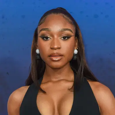 Normani wears a neutral makeup look with a subtle smoky eye