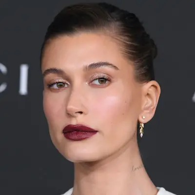 Hailey Bieber wears a subtle glittery makeup look with bold lipstick