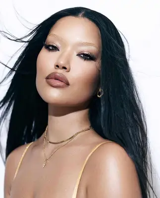 model wears smoky eyes with bleached eyebrows and nude lips