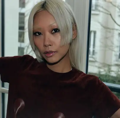 model is wearing deep black kohl eyeliner around the perimeter of the eyes and metallic lip gloss