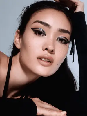 model wears 60s inspired black winged abstract liner 