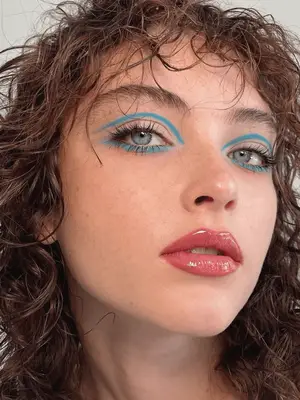 model wears 60s inspired twiggy blue eyeliner applied in the crease and under the eyes