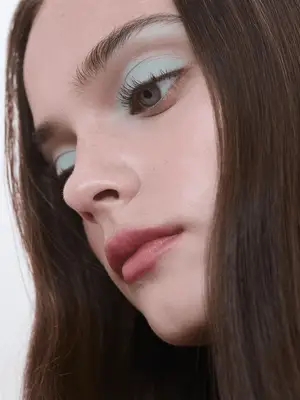 model wears matte mint green eyeshadow