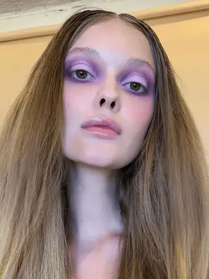 model wears matte lilac and purple 60s inspired eyeshadow