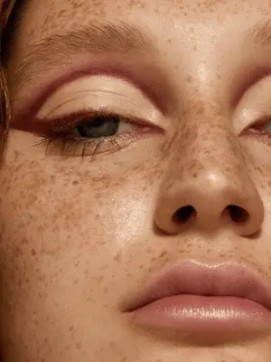 model wears 60s style burgundy shadow lined in the crease and top lashline