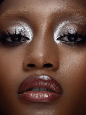 model wears 60s style spidery lashes and silver metallic eyeshadow